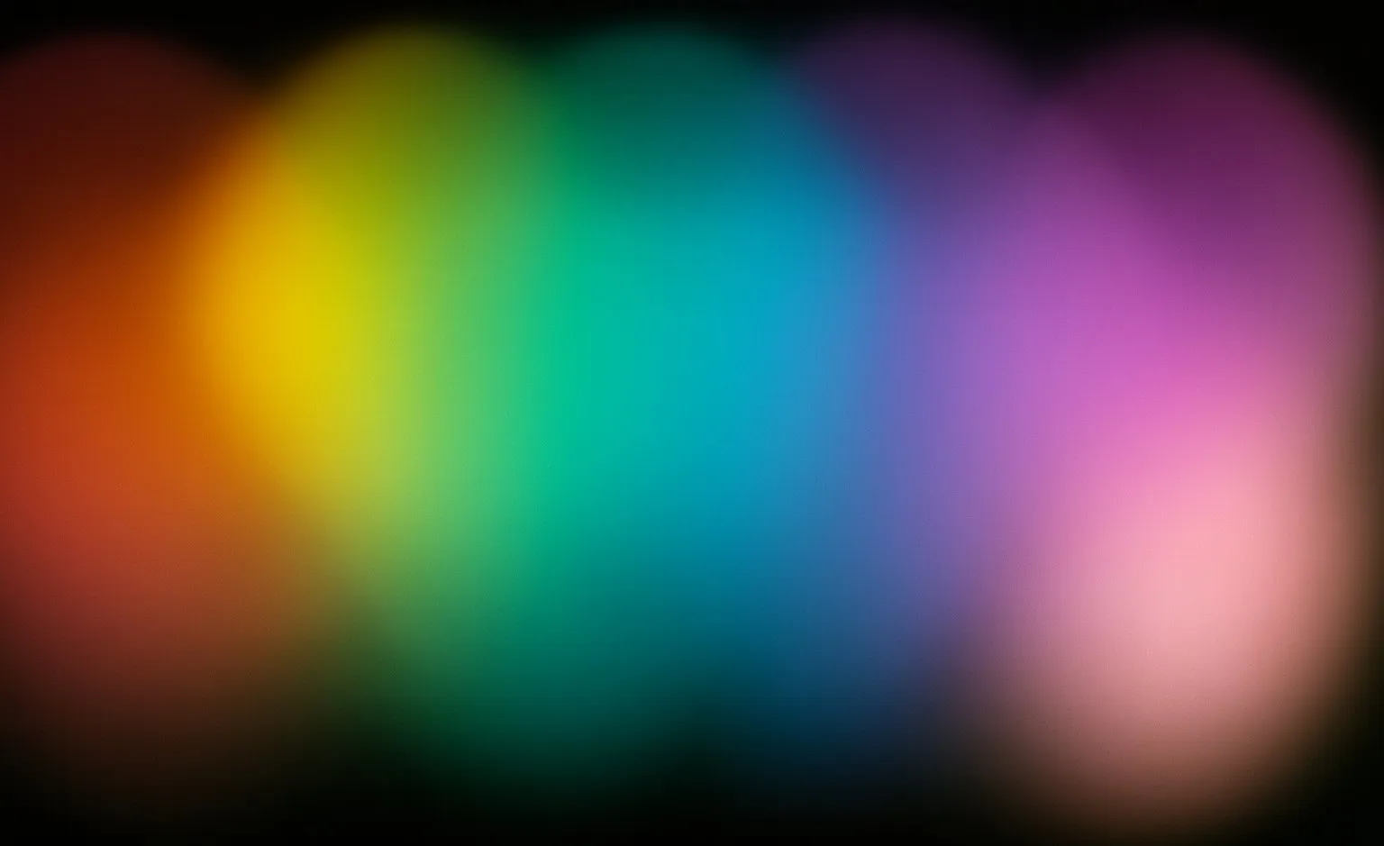A soft full-spectrum gradient running from red through green and blue to violet — the aura colour range Emily photographs.