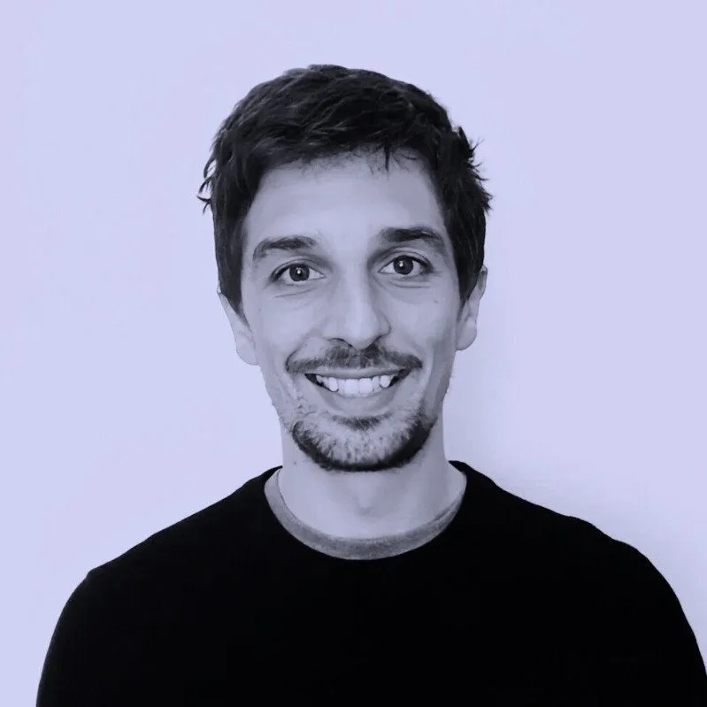 Jeffrey Althouse, smiling, in a black t-shirt against a pale lilac backdrop.