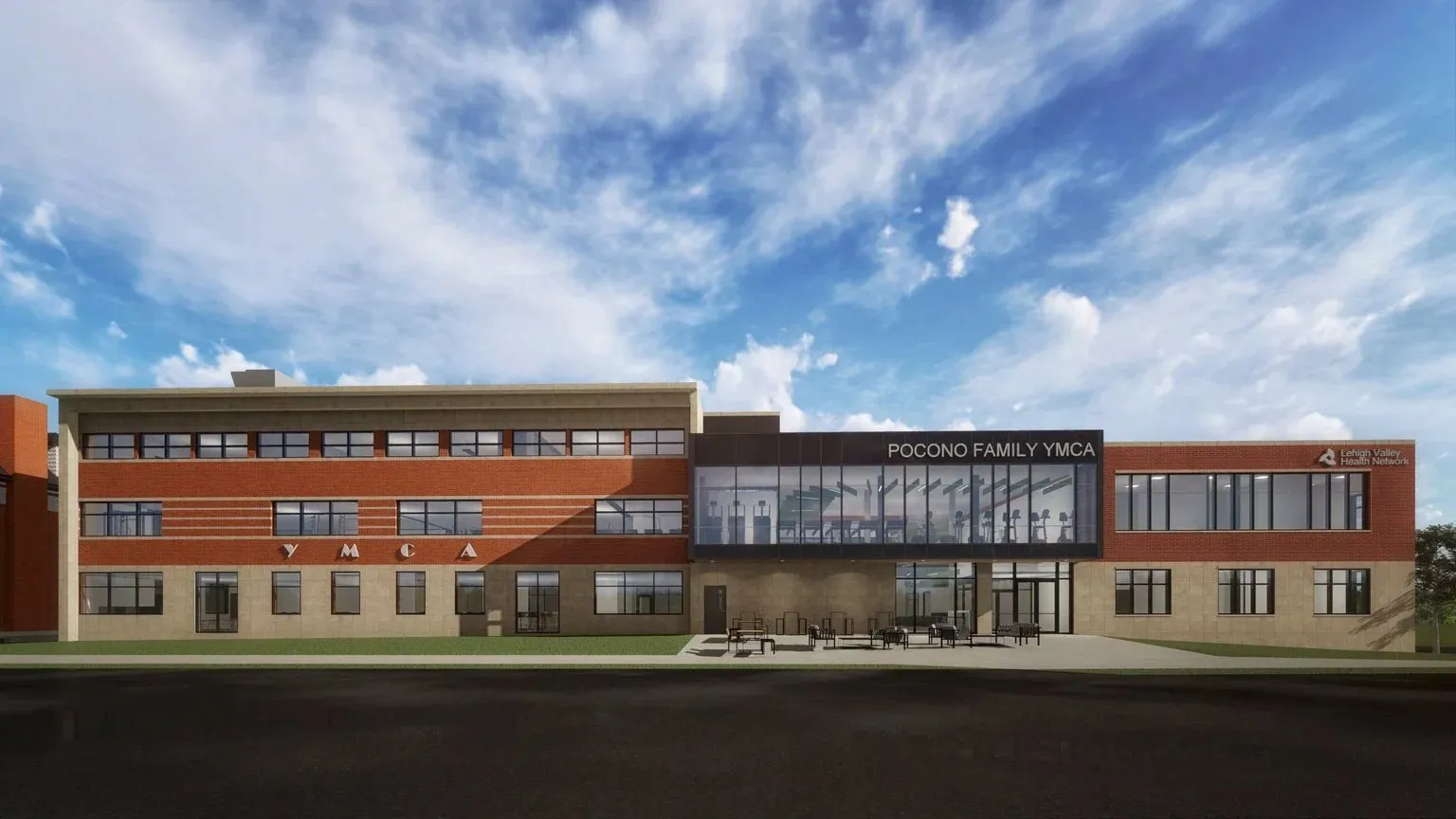 An architectural rendering of the expanded Pocono Family YMCA — a long two-storey brick and timber building under a wide blue sky.